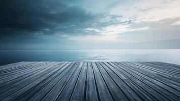 Wooden pier with a cloudy sky in the background. The sky is dark and the water is calm photo