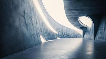 Large, empty, and dark tunnel with a slanted ceiling. The tunnel is made of concrete and has a very industrial feel photo