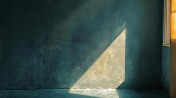 Room with a window and a wall with a shadow on it. The room is empty and the light is coming in through the window photo
