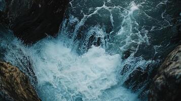 Large body of water with a lot of white foam and bubbles. The water appears to be rough and choppy, with waves crashing against the rocks. Concept of power and energy photo