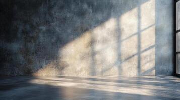 Large window in a room with a wall that is grey and has a shadow on it. The room is empty and has a very plain and simple appearance photo