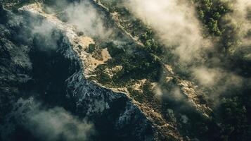 Mountain range with a foggy sky and trees. The sky is hazy and the trees are green photo