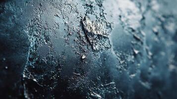 Close up of a wall with a blue background and a lot of texture. The wall appears to be made of ice and has a rough, jagged surface. Concept of coldness and ruggedness photo