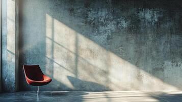 Red chair is sitting in front of a wall. The chair is facing the wall and the wall is made of concrete. The room is empty and the chair is the only object in the room photo