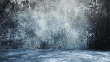 The room is a large, empty space with a blue wall. The wall is covered in a textured, slightly grainy paint that gives it a somewhat rough, unfinished appearance photo