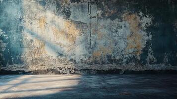 Large, empty room with a wall that is covered in graffiti. The wall is mostly gray, but there are some yellow and brown spots. The room is very bare and empty, with no furniture or decorations photo