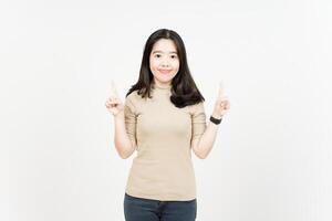 Showing Product and Pointing Up Of Beautiful Asian Woman Isolated On White Background photo
