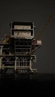 A towering oil rig with a clock atop, standing tall in the middle of the ocean video