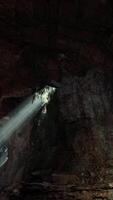 Sunlight streaming through a cave, creating a mesmerizing volume of light video