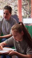 Teenager adolescent participates in a drawing activity as part of psychotherapy. The session helps express personal struggles through art, emotional support from mother and psychologist. Camera B. video