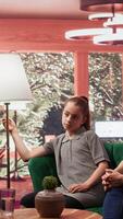 Mother bringing her zoned out dissociated teen girl at a therapy session with psychiatrist, adolescent suffering from depersonalization and disconnection from reality. Parent struggling. Camera B. video