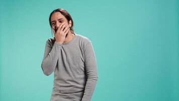 Portrait of cheerful man laughing hard, amused by funny joke, studio background. Happy Arab person chuckling and giggling, delighted by comedy, feeling entertained, camera B video