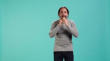 Disappointed man admonishing friend over debacle, isolated over blue studio background. Upset person in disagreement with mate, pointing finger and lecturing him, camera A video