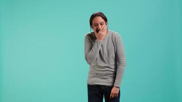Portrait of cheerful man laughing hard, amused by funny joke, studio background. Happy Arab person chuckling and giggling, delighted by comedy, feeling entertained, camera A video