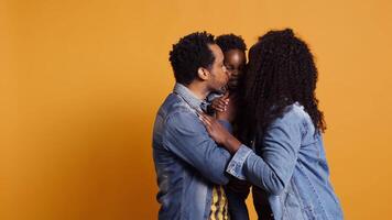 Portrait of african american family with a little child posing on camera, showing gratitude and sympathy towards each other and feeling satisfied. Happy mom and dad holding their boy. Camera B. video