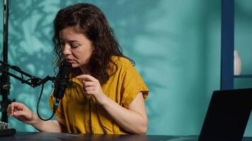 Content creator preparing podcast recording equipment, waiting for guests to arrive and film . Online show host testing professional microphone before conducting interviews in studio, camera A video