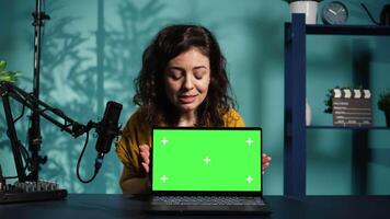 Online show host being sponsored by partnering brand to do isolated screen laptop unboxing content. Tech expert does influencer marketing, doing chroma key notebook product placement, camera B video