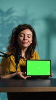 Vertical Tech guru excited to review newly released chroma key tablet, comparing features with older models. Influencer filming , analyzing latest generation of green screen digital device, camera B video