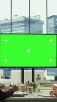 Vertical Diverse work team discusses corporate strategies with a big green screen, meeting in high end boardroom to examine market trends. Sharing new ideas for business growth and expansion. Camera B. video