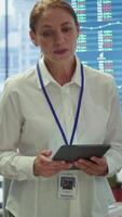 Vertical Business coworkers engaging in a collaborative startup meeting, utilizing interactive board and tablet with data visualization to brainstorm solutions and enhance project outcomes. Camera A. video