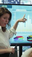 Vertical PR team presenting infographics and digital marketing insights for growth, showcasing the impact of recent campaigns and outlining plans for future development initiatives in workspace. Camera A. video
