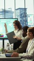 Vertical Business associates reviewing key performance indicators within the enterprise activity. Conducting evaluations and discuss training to foster development, enhance team efficiency. Camera B. video
