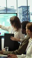 Vertical Employees team analyzing infographics to offer solutions for the new project, looking to finish tasks before deadline. Enterprise coworkers attending problem solving conference in boardroom. Camera B. video