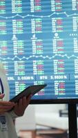Vertical Diverse coworkers gather in a boardroom to brainstorm innovative ideas, analyze market data and develop strategic plans to improve business performance. Enterprise briefing meeting. Camera A. video