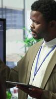 Vertical Coworkers engaging in a problem solving meeting at a corporation, using an interactive board to visualize data and develop solutions for complex challenges. Analysis presentation. Camera A. video