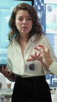 Vertical Organizational staff studying infographics on a tablet during collaborative meeting, using latest budget reports and data visualization tools to achieve project goals. Camera A. video