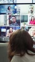 Vertical Company employees attending a meeting via videocall with investors, discussing about the future of the enterprise. Advisory board and workers examining infographics data for management. Camera A. video