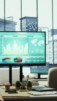 Vertical Sleek corporate office with a computer displaying detailed infographics, perfect for executive business meetings or financial planning and project development in a multinational company. video