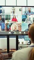 Vertical Marketing team analyzing big data insights on online videoconference with the advisory board, creating detailed infographics to present progress and goals. Remote presentation. Camera B. video