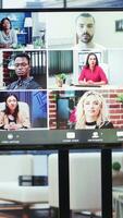 Vertical Company employees attending a meeting via videocall with investors, discussing about the future of the enterprise. Advisory board and workers examining infographics data for management. Camera A. video