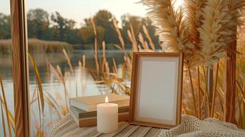 A picture frame, a candle, and a book on a table photo