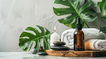 Spa products with a bottle of essential oil and towels photo