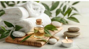 Spa products with towels and candles on a wooden tray photo