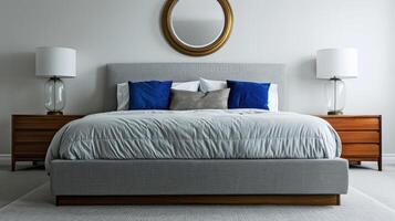 A bedroom with a bed, nightstands and a mirror photo
