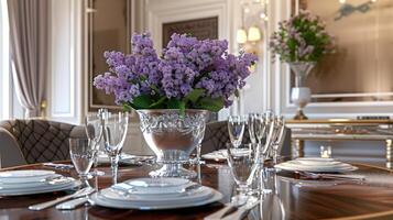 A table with a vase of flowers and silverware photo