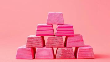 A pyramid of pink blocks on a pink background photo