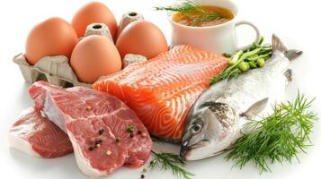 Fish, eggs, and meat on a white plate photo