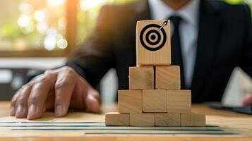A man in a suit is holding a wooden block with a target on it photo