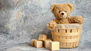 A teddy bear sitting in a basket with wooden blocks photo