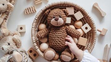 A child's hand is holding a teddy bear in a basket photo