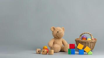 A teddy bear and wooden blocks on a gray background photo
