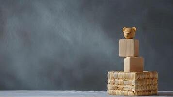 A wooden bear is sitting on top of a wooden block photo