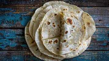Three tortillas on a blue wooden table photo