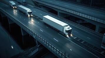 A group of trucks traveling on a highway at night photo