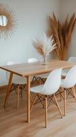 A dining table with white chairs and a mirror photo