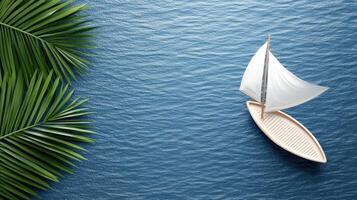 A sailboat floating on the ocean with palm leaves photo